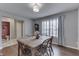 Bright dining area with hardwood floors, natural light from the window, and a traditional wooden table at 5617 Gainesway Dr, Greenwood, IN 46142