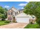Attractive two-story home with a two-car garage, manicured lawn, brick details, and classic curb appeal at 5617 Gainesway Dr, Greenwood, IN 46142