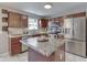 Functional kitchen with stainless steel appliances, wooden cabinets, and a central island with a granite countertop at 5617 Gainesway Dr, Greenwood, IN 46142
