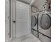Convenient laundry room with modern front-load washer and dryer units for efficient laundry care at 5617 Gainesway Dr, Greenwood, IN 46142