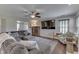 Spacious living room showcasing hardwood floors, a large sectional, fireplace, and an open floor plan at 5617 Gainesway Dr, Greenwood, IN 46142