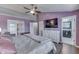 Well-appointed primary suite with a ceiling fan, hard wood floors, and an ensuite bathroom at 5617 Gainesway Dr, Greenwood, IN 46142