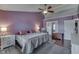 Spacious main bedroom with a ceiling fan, hardwood floors, a gray area rug and an attached closet at 5617 Gainesway Dr, Greenwood, IN 46142