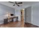 Home office or bedroom space with hardwood floors, a ceiling fan and a desk with storage drawers at 5617 Gainesway Dr, Greenwood, IN 46142