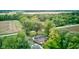 Overhead view of home with deck, surrounded by lush trees and open fields at 5750 W 650 N, Thorntown, IN 46071