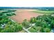 Lovely home nestled among vibrant green trees with a large field behind property at 5750 W 650 N, Thorntown, IN 46071