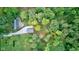 Aerial shot of a charming home nestled among lush trees with a long driveway at 5750 W 650 N, Thorntown, IN 46071