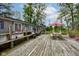 Large wooden deck featuring plenty of space for tables, chairs, and lounging furniture, with a view of the backyard at 5750 W 650 N, Thorntown, IN 46071