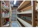 Well-organized basement storage with sturdy wooden shelves for household supplies and a wine rack for bottles at 5750 W 650 N, Thorntown, IN 46071
