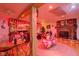 Festive basement with a brick fireplace, wood floors, and Coca-Cola themed decor at 5750 W 650 N, Thorntown, IN 46071
