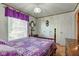 A serene bedroom features a wooden bed frame, bright window, and ample storage with double closets at 5750 W 650 N, Thorntown, IN 46071