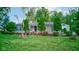 Quaint single story home featuring lush green lawn, mature trees, and an American flag displayed in the front yard at 5750 W 650 N, Thorntown, IN 46071