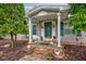Welcoming front porch featuring brick accents, decorative statues, and a quaint seating area at 5750 W 650 N, Thorntown, IN 46071