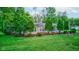 Charming single-story home surrounded by lush greenery, with a gazebo and an American flag at 5750 W 650 N, Thorntown, IN 46071