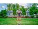 Charming ranch-style home with a lush green lawn, mature trees, and an American flag displayed in the front yard at 5750 W 650 N, Thorntown, IN 46071