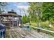 Charming screened-in gazebo on a deck, providing a cozy spot surrounded by lush greenery at 5750 W 650 N, Thorntown, IN 46071