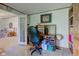 Functional home office with built-in desk, shelving, and carpeted floors, conveniently located near living area at 5750 W 650 N, Thorntown, IN 46071