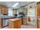 Well-lit kitchen with stainless steel appliances, wood cabinetry and functional center island at 5750 W 650 N, Thorntown, IN 46071