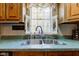 A bright kitchen features a double stainless sink with a window above, inviting natural light and views at 5750 W 650 N, Thorntown, IN 46071