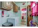 Bright laundry area with red accents, storage, and access to the bathroom at 5750 W 650 N, Thorntown, IN 46071
