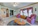 Comfortable living room with plush seating, a large window with curtains, and traditional furnishings at 5750 W 650 N, Thorntown, IN 46071