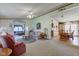 Inviting living room featuring a ceiling fan, floral decor, and open access to the dining area at 5750 W 650 N, Thorntown, IN 46071