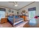 Cozy main bedroom with a four-poster bed, ceiling fan, and ample natural light, creating a peaceful retreat at 5750 W 650 N, Thorntown, IN 46071