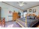Comfortable main bedroom with wood furniture, soft carpet, and lots of natural light, creating a peaceful retreat at 5750 W 650 N, Thorntown, IN 46071