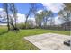 Spacious backyard with grass, trees, and a concrete patio, perfect for outdoor enjoyment at 6231 W Clinton St, Stilesville, IN 46180