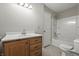 Bathroom with a single sink vanity, toilet, and shower over bath with white tile at 6231 W Clinton St, Stilesville, IN 46180