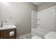 Clean bathroom featuring a tub with shower, sink with cabinet and neutral paint at 6231 W Clinton St, Stilesville, IN 46180