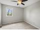 Cozy bedroom with neutral carpet, ceiling fan and a window offering plenty of natural light at 6231 W Clinton St, Stilesville, IN 46180