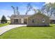 Inviting brick home with a well-manicured lawn and a curved driveway at 6231 W Clinton St, Stilesville, IN 46180