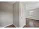 Hallway that leads to a bedroom showing neutral walls and laminate flooring at 6231 W Clinton St, Stilesville, IN 46180