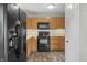 Modern kitchen with stainless appliances, wood cabinets and laminate flooring, ideal for cooking and entertaining at 6231 W Clinton St, Stilesville, IN 46180