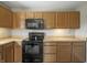 Spacious kitchen featuring modern black appliances and wood cabinetry, perfect for preparing culinary delights at 6231 W Clinton St, Stilesville, IN 46180