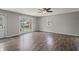 Bright living room features laminate flooring, ceiling fan, and large picture window providing plenty of natural light at 6231 W Clinton St, Stilesville, IN 46180