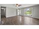 Bright living room featuring new floors, and a large window offering expansive views of the front yard at 6231 W Clinton St, Stilesville, IN 46180
