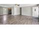 Spacious living room with wood-look flooring and ceiling fan open to the kitchen in this well lit open floorplan at 6231 W Clinton St, Stilesville, IN 46180