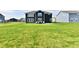 Spacious backyard with a dark siding house, patio, and ample green space for recreation and entertaining at 6398 Marden Trl, Brownsburg, IN 46112
