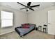 Cozy bedroom with neutral walls, ceiling fan, and a comfortable bed next to a bright window at 6398 Marden Trl, Brownsburg, IN 46112