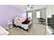 Bright bedroom with pastel purple walls, a silver metal frame bed, and lots of natural light from the windows at 6398 Marden Trl, Brownsburg, IN 46112