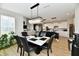 Bright dining area with a modern chandelier, seating for six, and views of the living room and kitchen at 6398 Marden Trl, Brownsburg, IN 46112