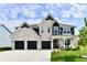 Beautiful white brick home with a three-car garage, well-maintained lawn, and welcoming front porch at 6398 Marden Trl, Brownsburg, IN 46112