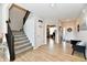 Bright and open foyer featuring a staircase, wood floors, and inviting decor at 6398 Marden Trl, Brownsburg, IN 46112