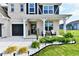 Charming front porch with seating, decorative plants, and a welcoming entrance to a beautifully landscaped home at 6398 Marden Trl, Brownsburg, IN 46112