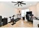 Home gym/office featuring workout equipment, desk with computer, and a ceiling fan at 6398 Marden Trl, Brownsburg, IN 46112