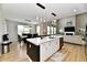 Bright kitchen with an island featuring bar stools, seamlessly flowing into dining and living areas at 6398 Marden Trl, Brownsburg, IN 46112