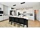 Open-concept kitchen with a large island, white cabinetry, stainless steel appliances, and bar seating at 6398 Marden Trl, Brownsburg, IN 46112