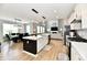 Spacious kitchen with island, stainless appliances, gas range, dining area, and open to the living room at 6398 Marden Trl, Brownsburg, IN 46112
